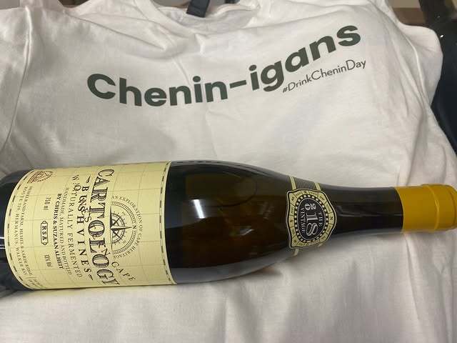 Alheit Cartology Chenin Blanc/Sémillon bottle resting on fabric, showcasing minimal-label design from South Africa.