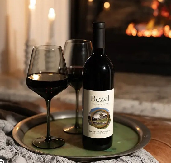  2022 Cabernet Sauvignon placed on a serving tray with two glasses of the wine from Woodland Hills Wine Company. 