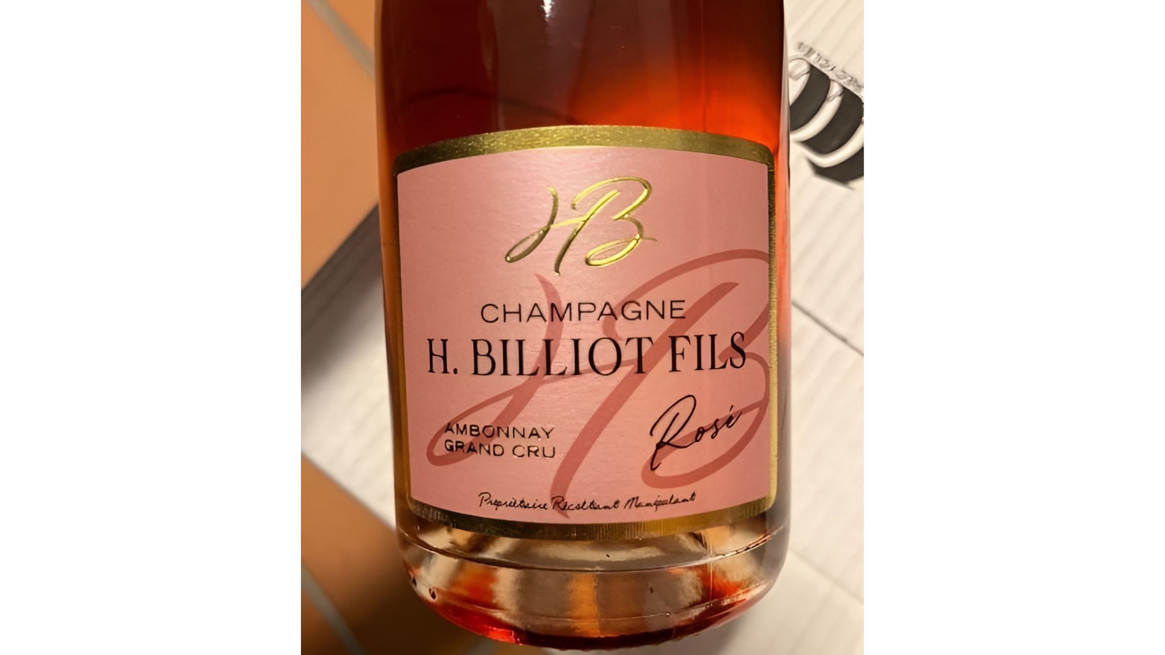 H. Billiot Fils Rosé Grand Cru Champagne bottle label close-up in soft pink tones, sold by WHWC.