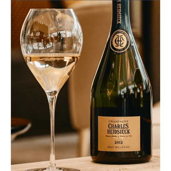 2012 Charles Heidsieck Brut Champagne with golden bubbles served in a tulip glass, highlighting elegance.