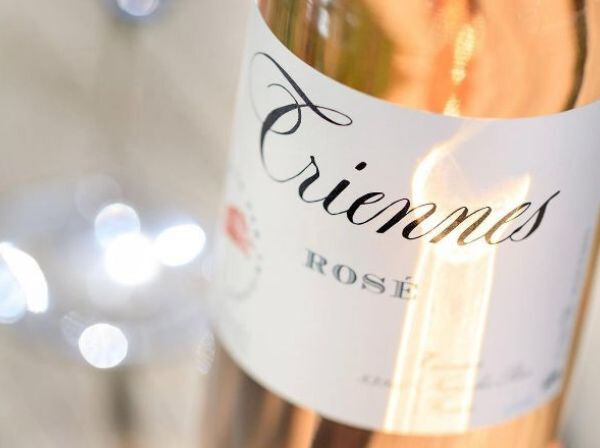 Close-up of a Triennes Rosé wine bottle, perfect for pairing with light BBQ dishes like chicken and seafood.