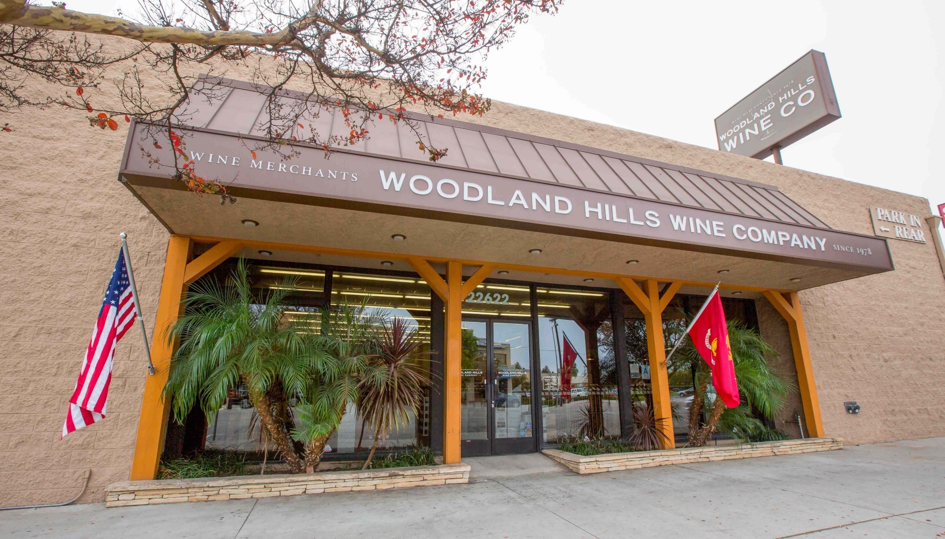 The front entrance of Woodland Hills Wine Company, USA, welcoming visitors to explore a variety of top-tier wines including Gamay.