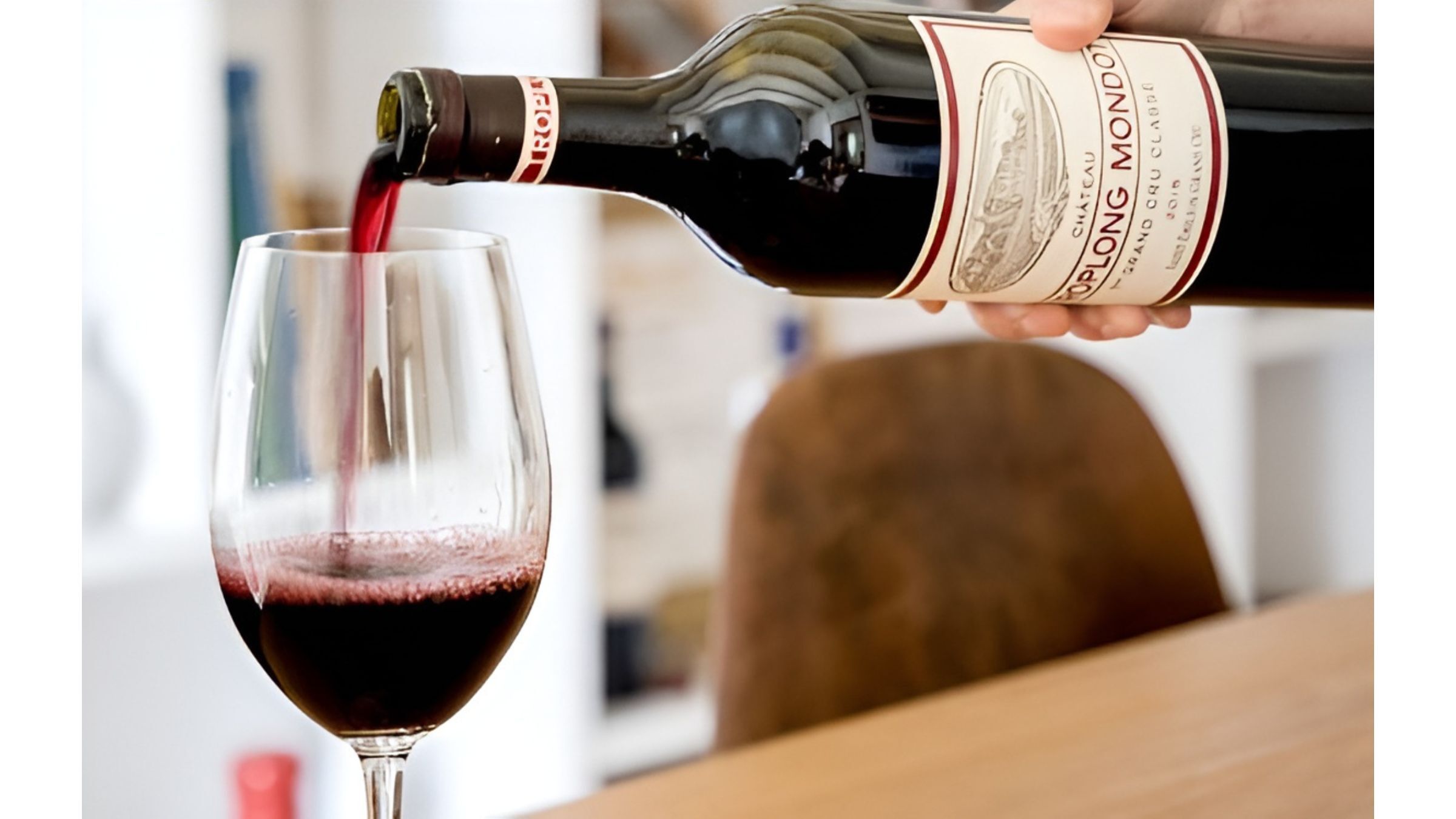 Red wine bought from WHWC is being poured into a glass, capturing a romantic moment for a Valentine’s dinner.