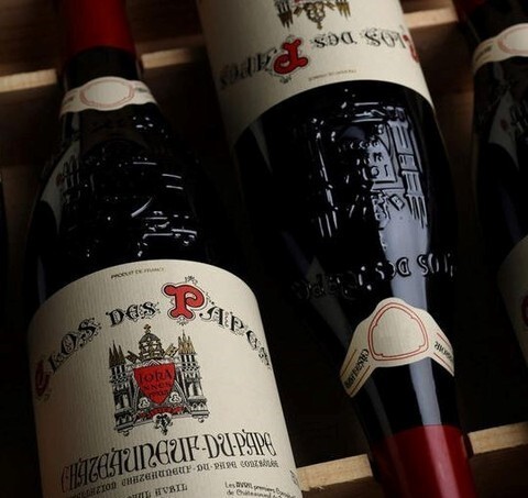 A pristine cellar at Woodland Hills Wine Company, showing perfectly stored aged wine bottles with labeled provenance.