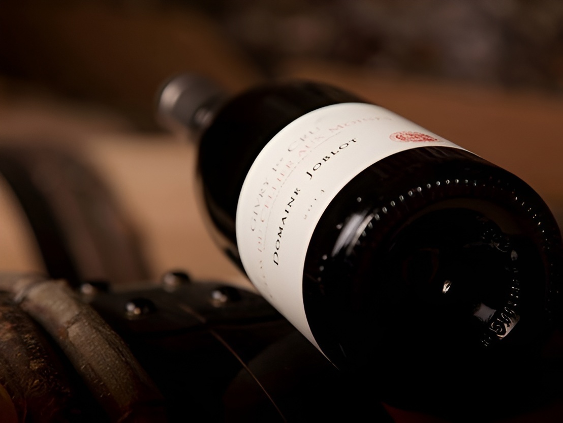 Elegant bottle of wine resting on natural wood, sold by Woodland Hills Wine Company. 