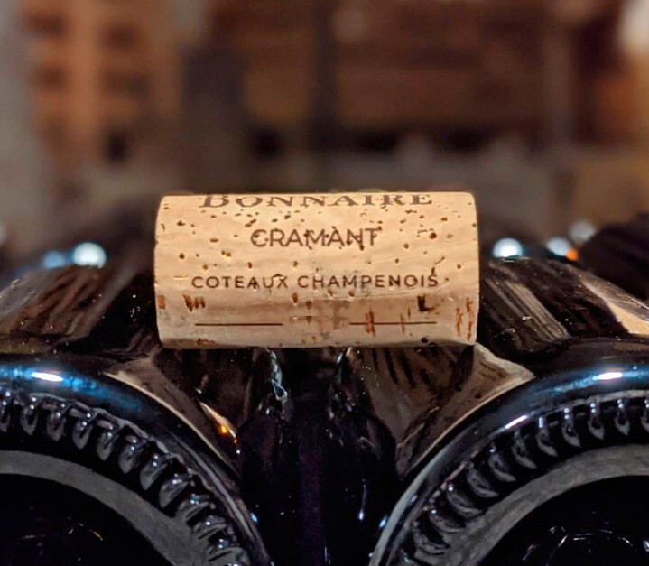 The 94-Point Château La Tour Carnet 2020 sold by Woodland Hills Wine Company, placed on a table.